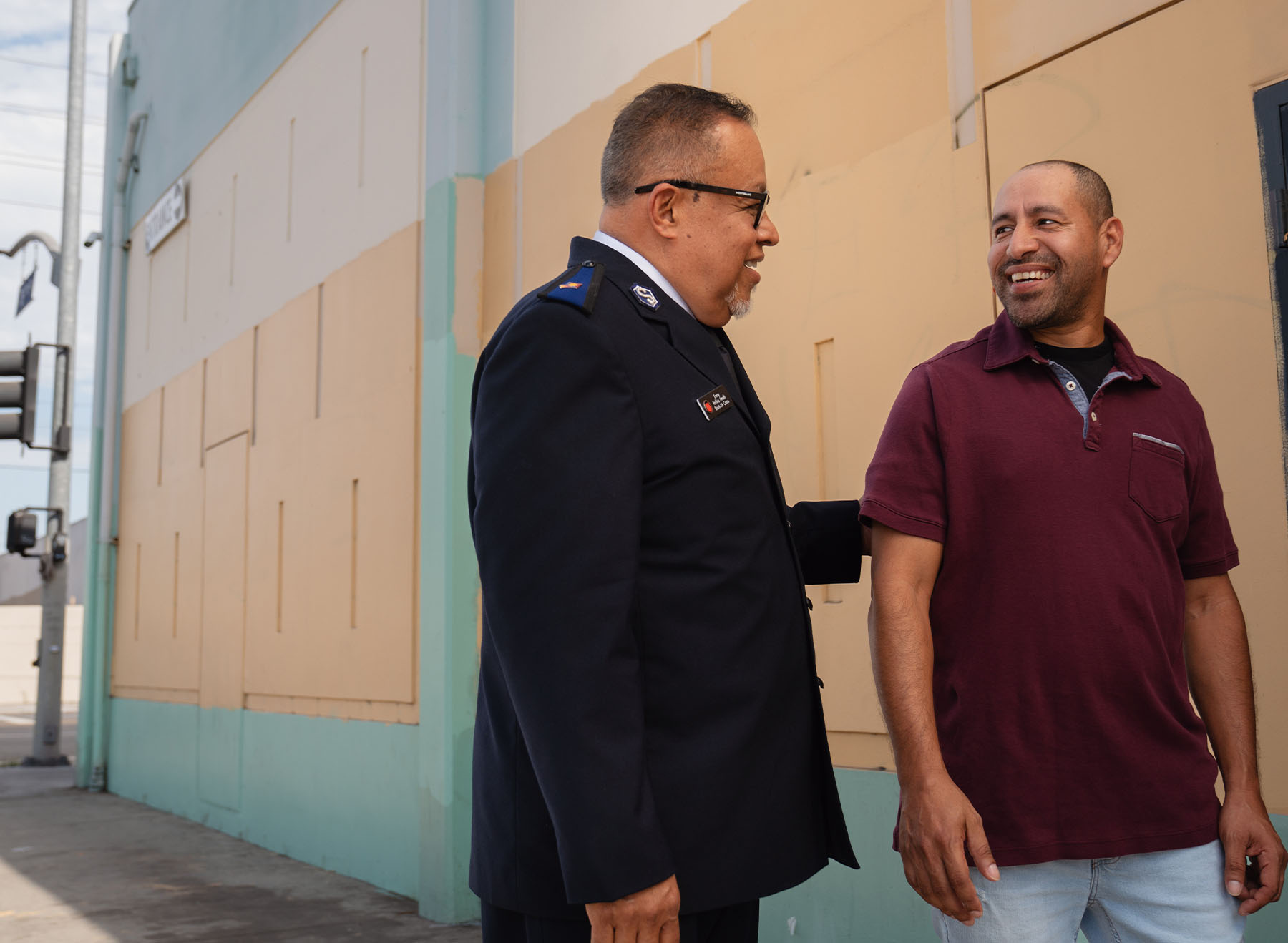 Salvation Army Officer talking and smiling with a community member.