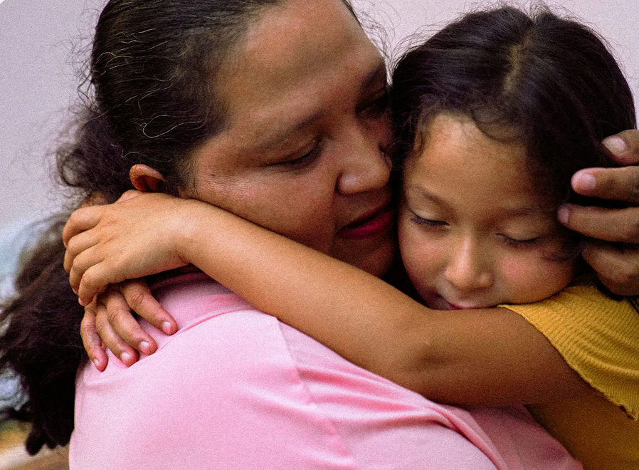 A mom hugging her child